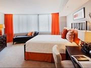 Washington apartment for rent - A bedroom with a large bed and a black couch.