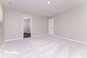 Four Oaks house for rent - A spacious empty room with a doorway leading to another room.