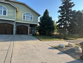 Silt house for rent - A house with a grey garage door and a brown door.