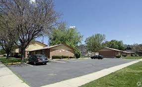 Denver apartment for rent - A residential area with houses and cars.