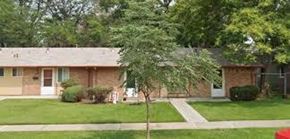 Denver apartment for rent - A small house with a white door and a brown roof.