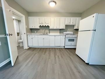 Louisville apartment for rent - A kitchen with white cabinets and appliances.