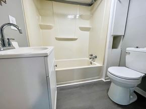 Louisville apartment for rent - A white bathroom with a toilet, sink, and bathtub.