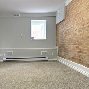 Brandon apartment for rent - A room with a window and a brick wall.