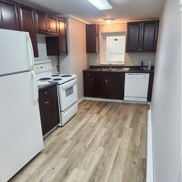 Brandon apartment for rent - A kitchen with a white fridge, white stove, and white dishwasher.