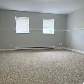 Brandon apartment for rent - A room with a carpeted floor and two windows.