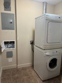 Calgary house for rent - A white dryer and washer in a laundry room.