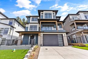 Chilliwack house for rent - A modern two-story house with a garage and a well-maintained lawn.