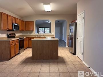 San Antonio house for rent - A kitchen with wooden cabinets and a central island.
