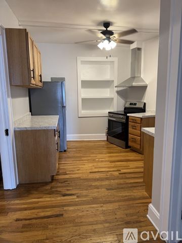 Valdese apartment for rent - A kitchen with wooden floors and a ceiling fan.