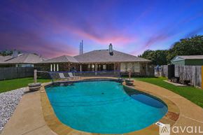 Keller house for rent - A pool with a basketball hoop and a house in the background.