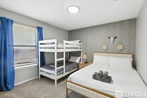 Keller house for rent - A bedroom with a white bed and bunk beds.