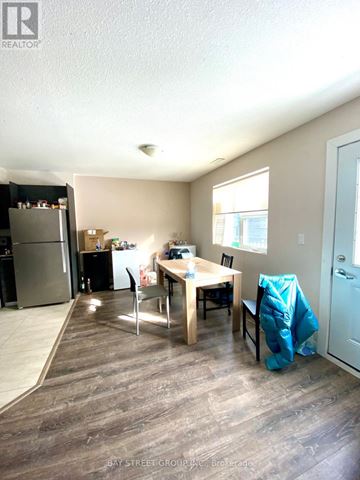 Waterloo townhouse for rent - A kitchen with a table and chairs in the middle of the room.