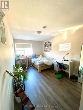 Waterloo townhouse for rent - A bedroom with a bed, desk, and chair.