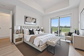 Kitchener apartment for rent - A bedroom with a large bed and a view of the outside.