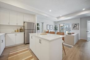 Kitchener apartment for rent - A kitchen with white cabinets and a wooden floor.