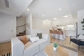 Kitchener apartment for rent - A living room with a white couch and a coffee table.