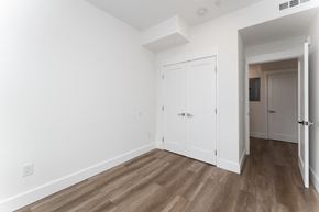 Washington apartment for rent - A room with a white door and a wooden floor.