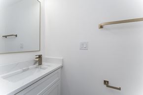 Washington apartment for rent - A white bathroom with a sink and a mirror.