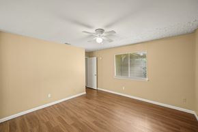 Houston house for rent - A room with a ceiling fan and wooden flooring.