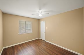 Houston house for rent - A room with a ceiling fan and a door.