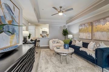 Atlanta apartment for rent - A living room with a blue couch and a ceiling fan.