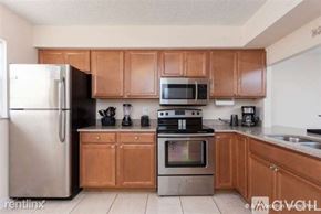 Daytona Beach apartment for rent - A kitchen with wooden cabinets and stainless steel appliances.