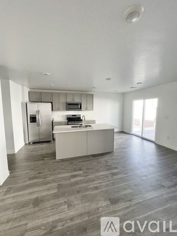 Cedar City townhouse for rent - A kitchen with a refrigerator, microwave, and oven is available for rent.