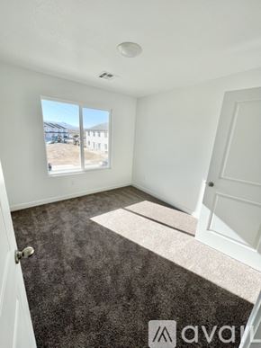 Cedar City townhouse for rent - A room with a carpeted floor and a window showing an outdoor view.