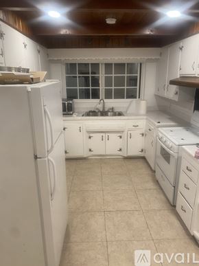 Alhambra house for rent - A kitchen with white appliances and cabinets.