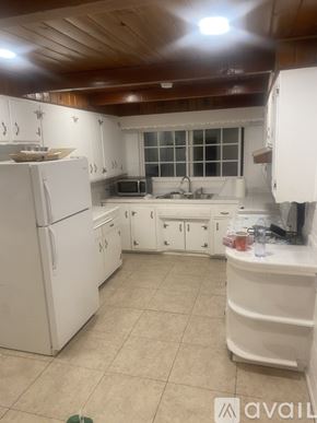 Alhambra house for rent - A kitchen with white appliances and cabinets.