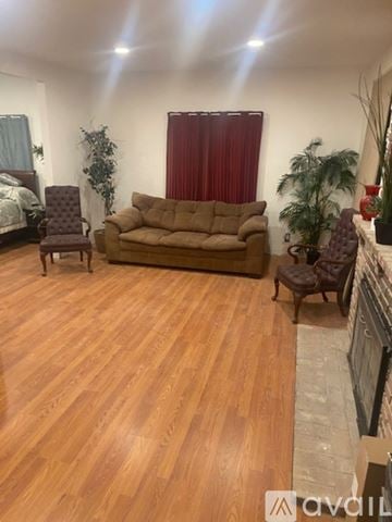 Alhambra house for rent - A living room with a brown couch and wooden floors.