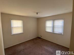 College Park townhouse for rent - A bedroom with a bed, desk, and chair.