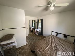 College Park townhouse for rent - A bedroom with a bed, desk, and chair.