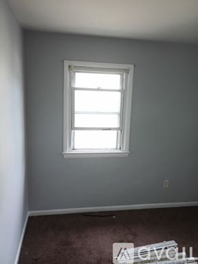 College Park townhouse for rent - A dining table with a vase of flowers on it.
