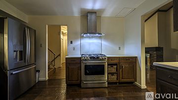 Reston house for rent - A modern kitchen with a stainless steel refrigerator and a center island with a sink.