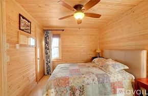 Sylva apartment for rent - A bedroom with a bed, a ceiling fan, and a window.