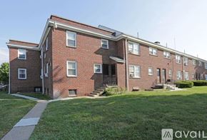 Oaklyn apartment for rent - A brick apartment building with a grassy front yard.
