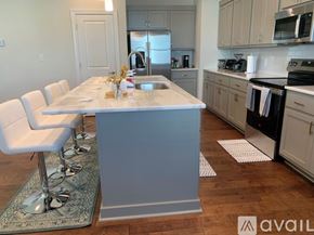Oxford house for rent - A kitchen with a table and chairs in the foreground and a refrigerator in the background.