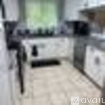 Wailuku house for rent - A blurry image of a kitchen with a counter and a sink.