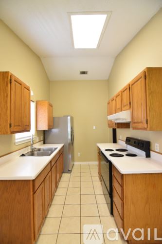 Killeen house for rent - A kitchen with wooden cabinets and a white counter top.