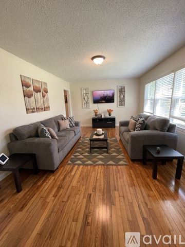 Albany house for rent - A living room with two grey couches and a coffee table.