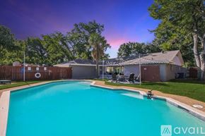 Desoto house for rent - A swimming pool in a backyard with a house and trees in the background.