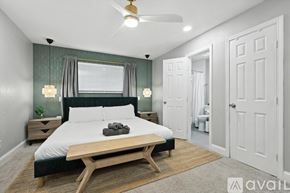 Desoto house for rent - A bedroom with a large bed and a wooden coffee table.