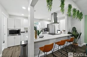 Desoto house for rent - A modern kitchen with white cabinets and a large island.