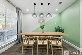 Desoto house for rent - A dining room with a wooden table and chairs.