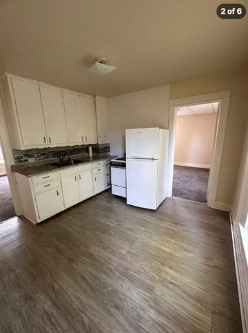 Wausau apartment for rent - A kitchen with white cabinets and a white refrigerator.