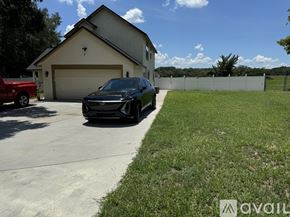 Orlando apartment for rent - A black car is parked in a driveway in front of a house.