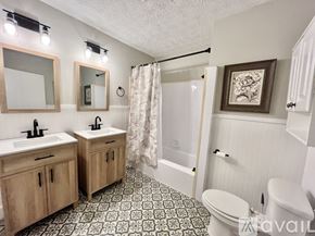 Decatur house for rent - A bathroom with two sinks and a shower.
