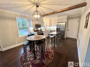 Decatur house for rent - A kitchen with a table and chairs in the middle of the room.